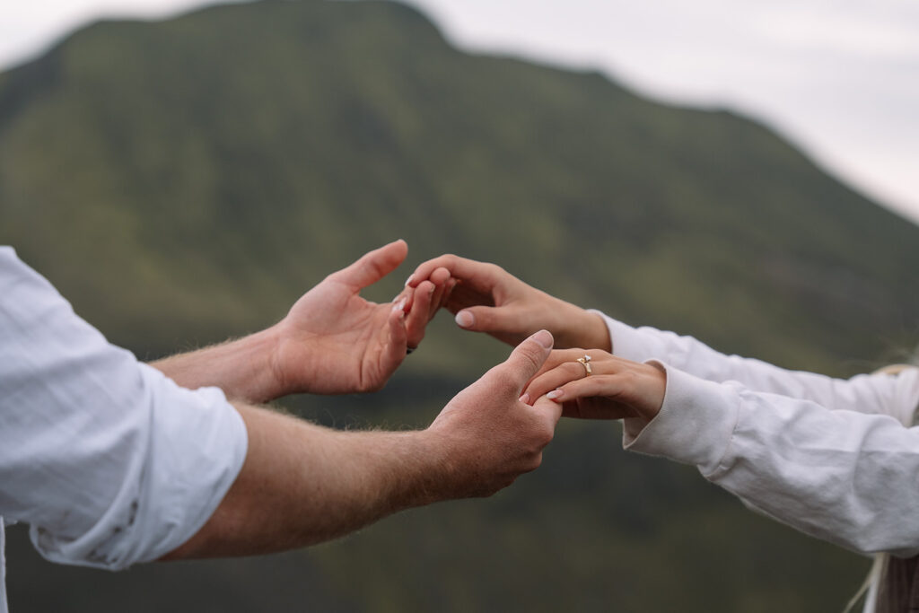 Close-up of the couple holding hands during their hot springs elopement in Iceland