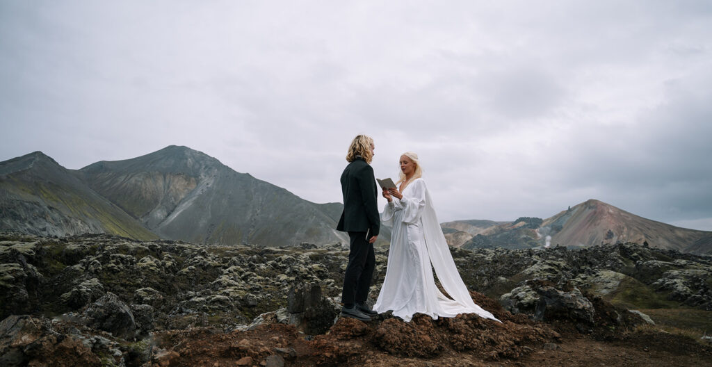 Bride reading vows during an intimate hot springs elopement in Iceland
