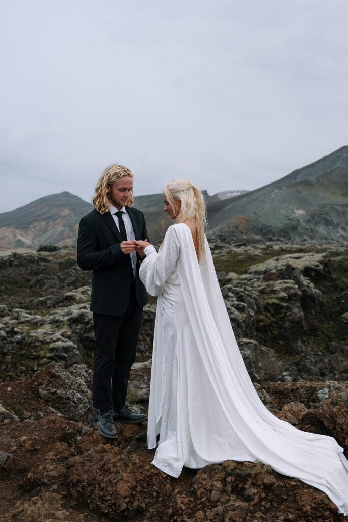 exchanging rings at their mountain Iceland elopement ceremony 