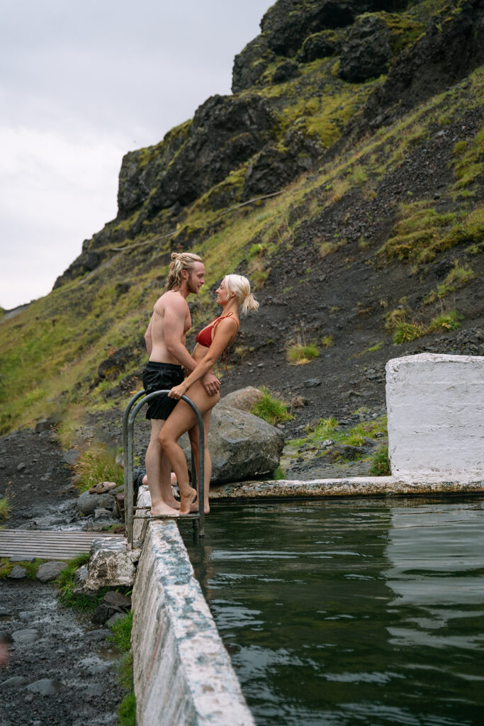 Romantic moment in a natural hot spring during their hot springs elopement