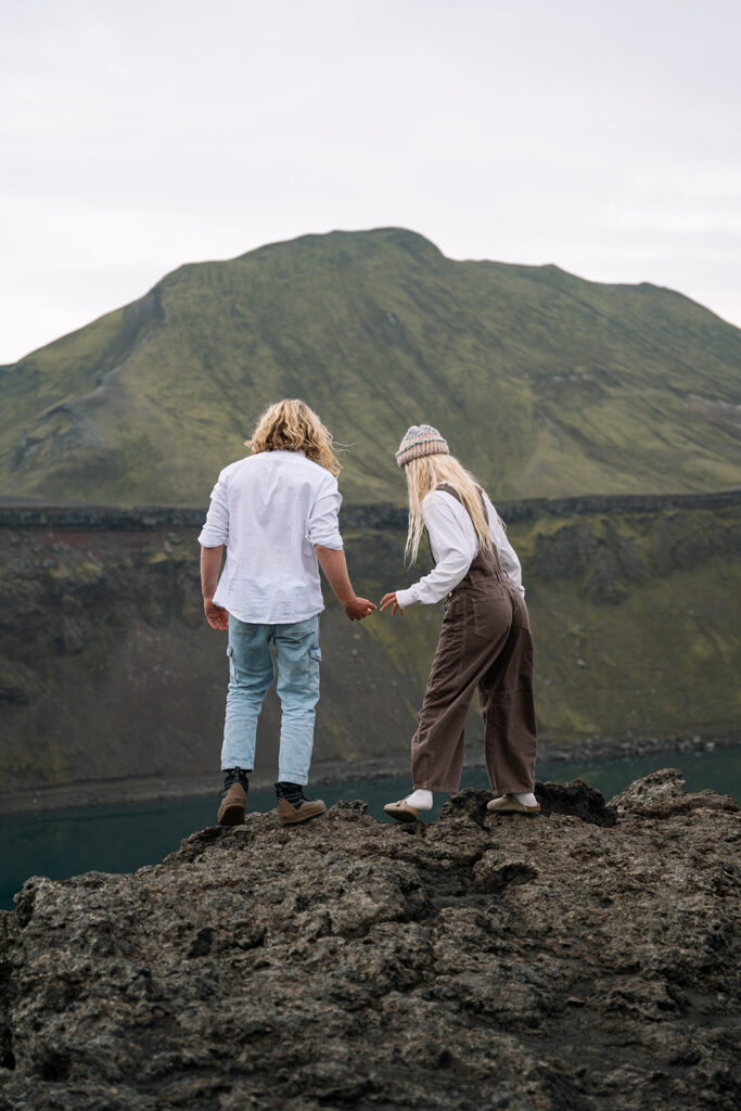 Couple walking toward the mountains during their hot springs elopement