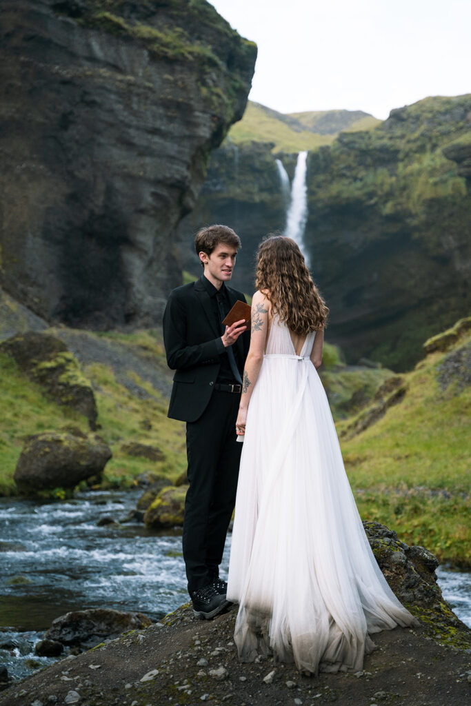 bride and groom exchange vow in iceland at skogasfoss