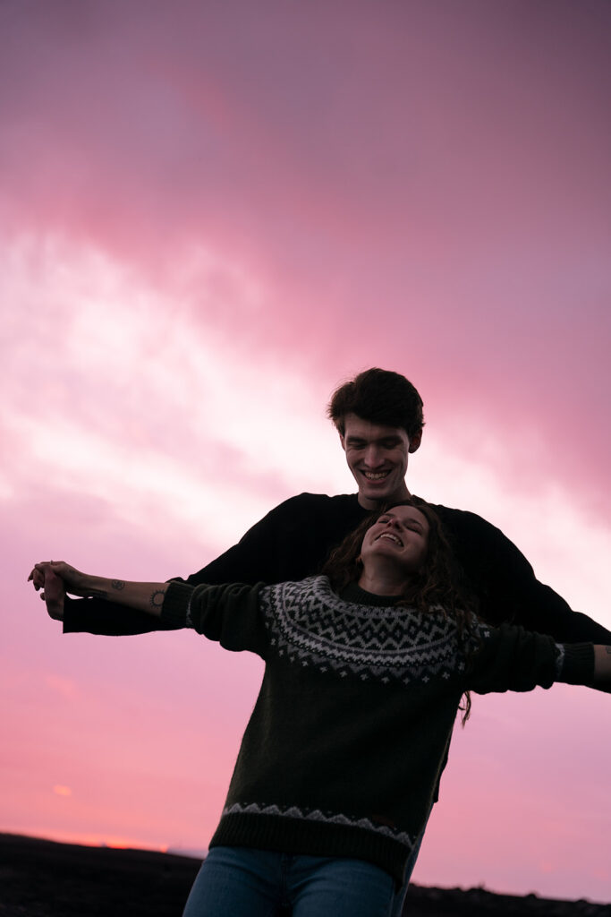 Fiery sky reflecting off the ocean during golden hour elopement portraits.