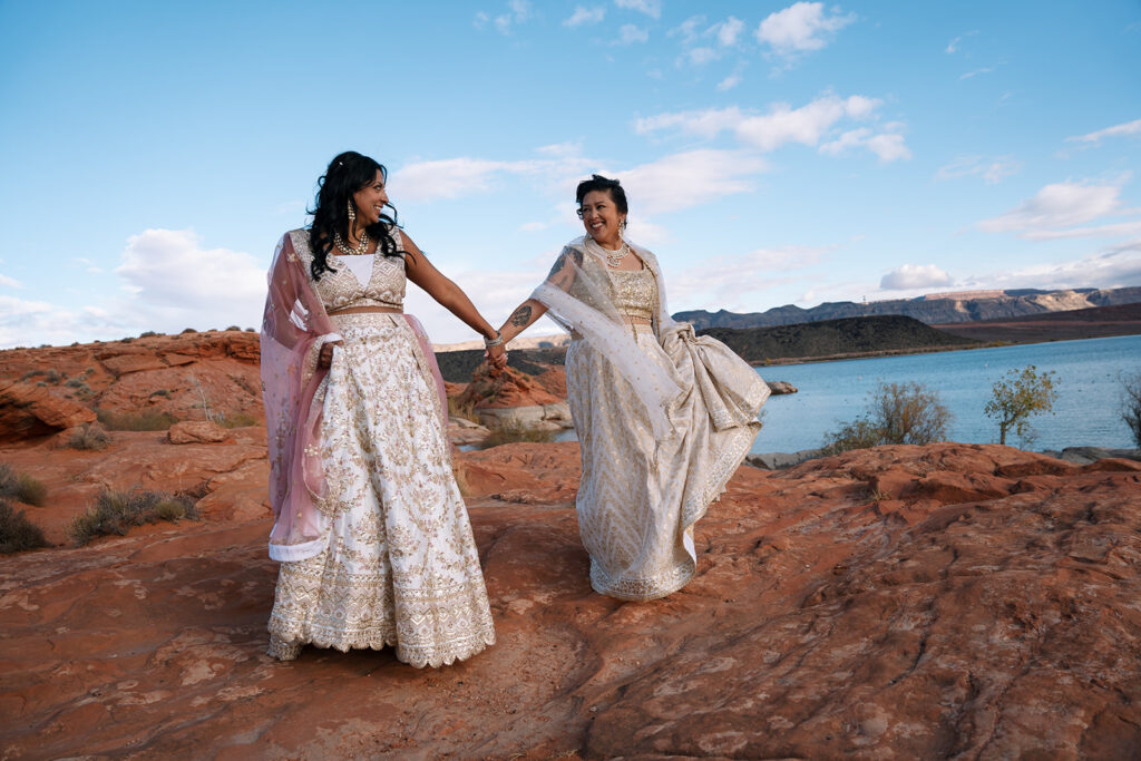 Couple walking hand-in-hand at their desert elopement in Utah, captured by an LGBTQ+ elopement photographer.