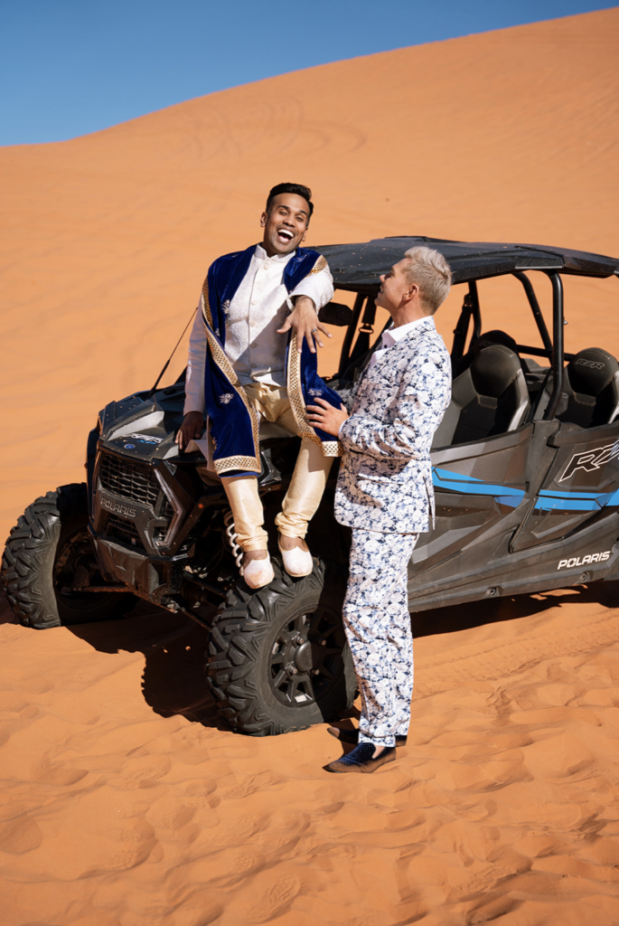 LGBTQ+ elopement photographer captures joyful post-engagement celebration in Utah’s coral dunes.